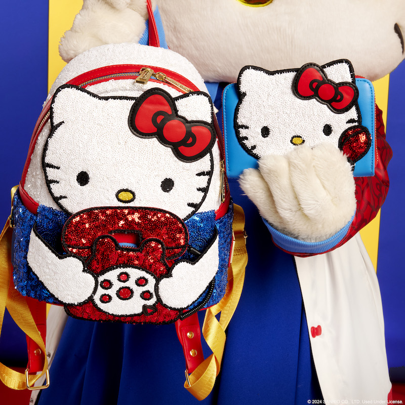 Hello Kitty holding the Loungefly Sanrio Hello Kitty 50th Anniversary Phone Sequin Mini Backpack and wallet 